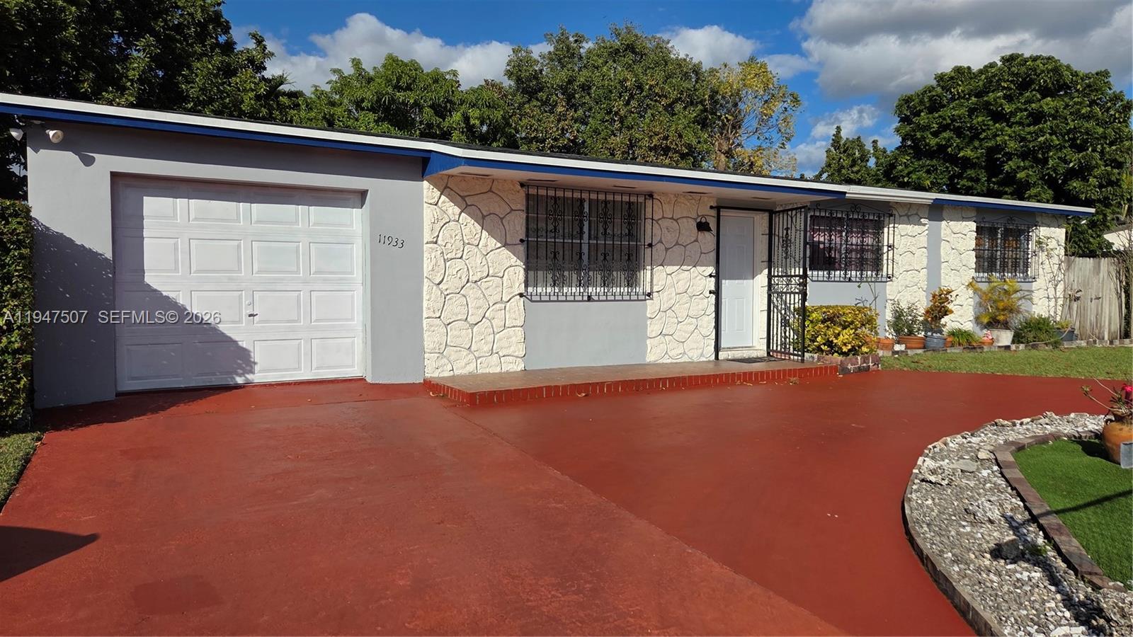 11933 Southwest 196th Terrace Miami, FL 33177 - Photo 5 of 29 a front view of a house with garden