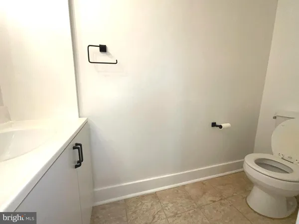 a view of empty room with wooden floor and fireplace