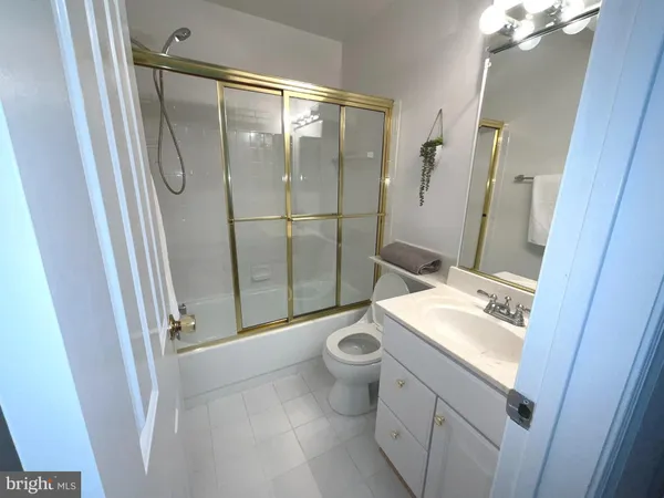 a en suite bathroom with a granite countertop window and a sink