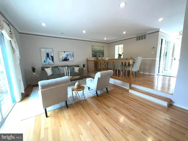 a living room with furniture window and wooden floor