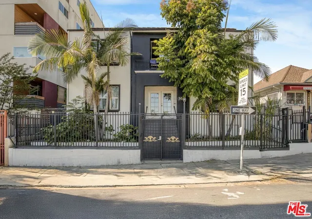 a view of a house with a iron fence