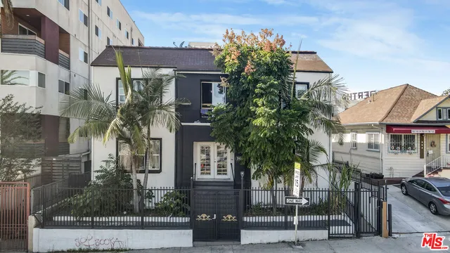 a front view of multiple houses with yard