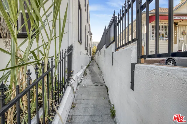 a hallway with a white comforter and pillows