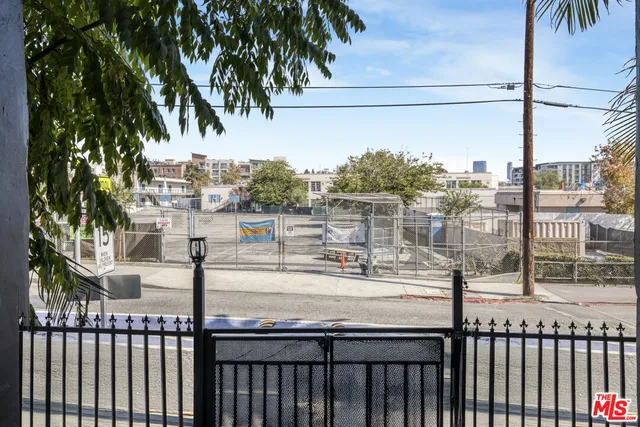 a view of a pathway of a house with wooden fence