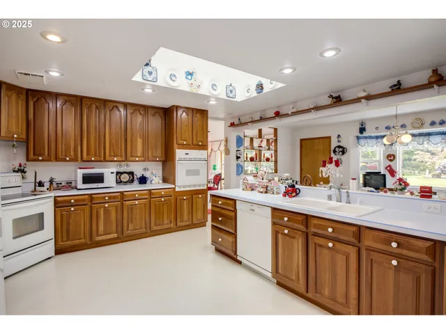 a large kitchen with stainless steel appliances lots of counter top space