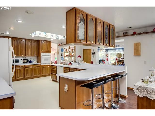 a kitchen with stainless steel appliances kitchen island granite countertop a sink and cabinets