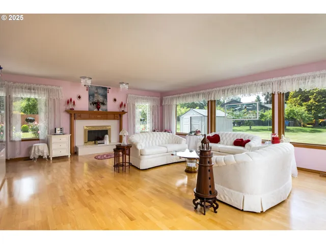 a living room with furniture a fireplace and a table