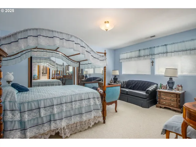 a bedroom with a bed a couch and dresser