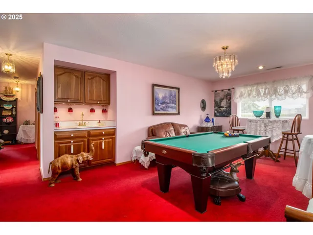 a room with furniture and pool table