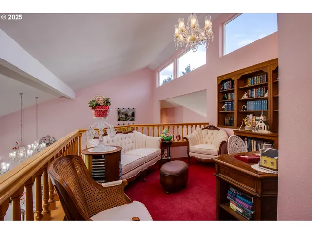 a living room with furniture and a book shelf