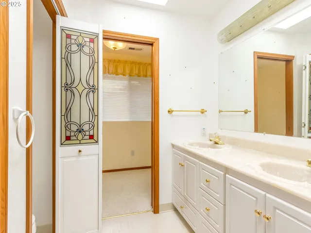 a bathroom with a granite countertop sink a mirror a shower and a shower