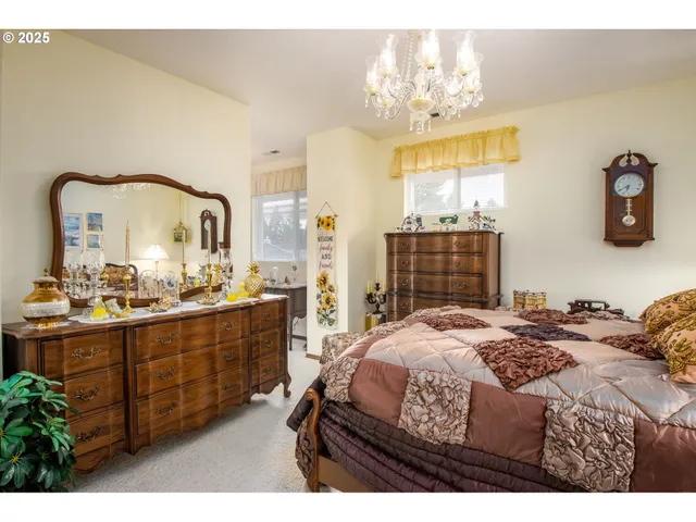 a bedroom with a bed and a mirror on dresser