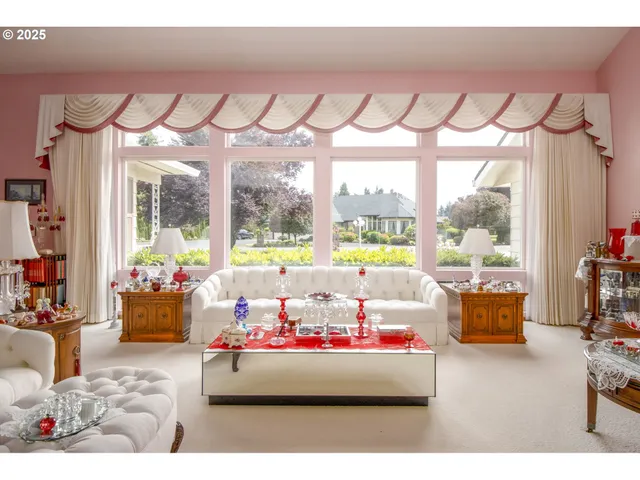 a bedroom with furniture and large window