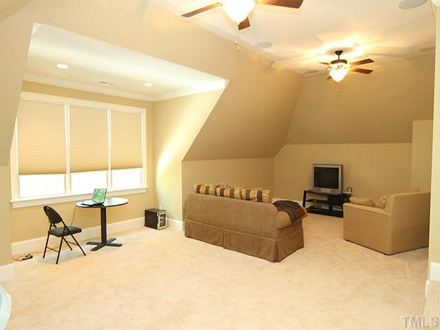 6828 Mactavish Way Raleigh, NC 27613 - Photo 15 of 25 a living room with furniture and a flat screen tv
