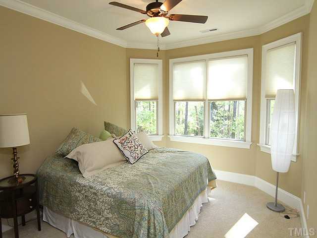 6828 Mactavish Way Raleigh, NC 27613 - Photo 17 of 25 a bedroom with a bed and a window