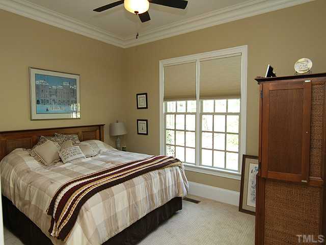 6828 Mactavish Way Raleigh, NC 27613 - Photo 20 of 25 a bedroom with a bed and a window