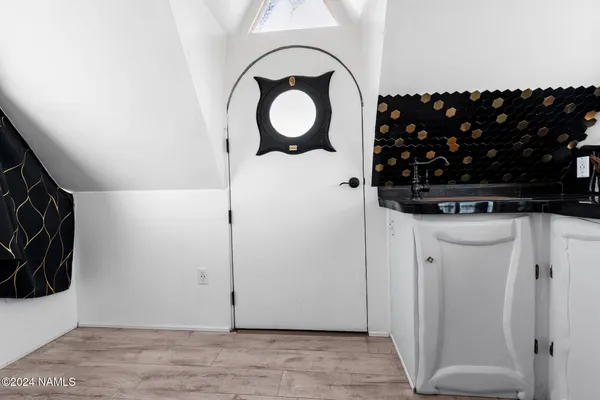 a view of a wooden house with a yard