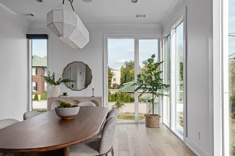 a living room with furniture a potted plant and a chandelier