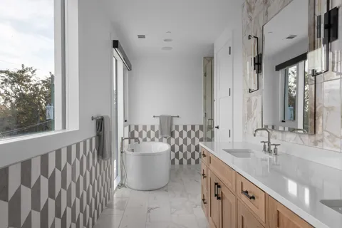a spacious bathroom with a double vanity sink and a mirror