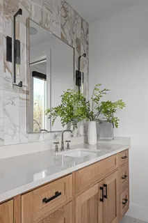 a bathroom with a sink a vanity and a mirror