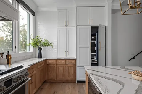 a kitchen with stainless steel appliances a sink stove and cabinets