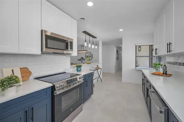 a kitchen with stainless steel appliances a stove microwave and refrigerator