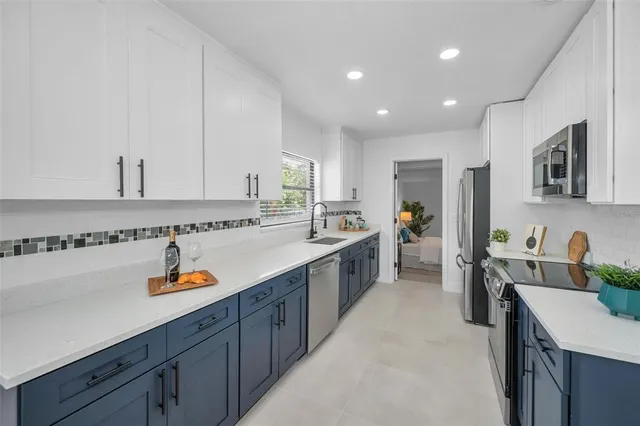 a kitchen with stainless steel appliances granite countertop sink stove and cabinets