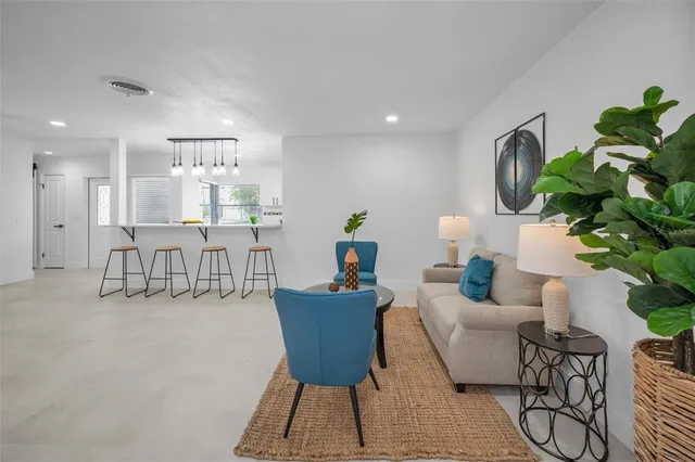 a living room with furniture and a chair