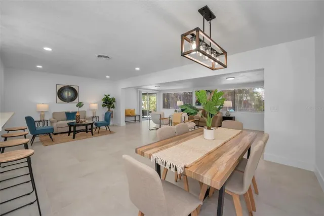 a spacious bedroom with a bed and a chandelier