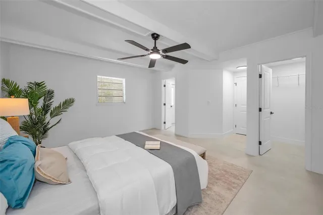 a view of a big room with wooden floor and windows