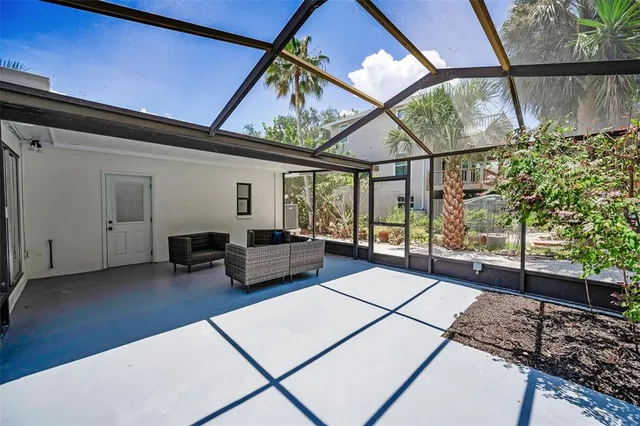 a view of a house with a yard and potted plants
