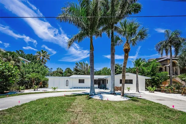 a house with palm tree in front of it