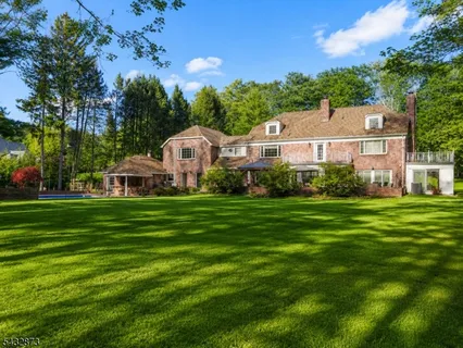 a aerial view of a house with a big yard and large trees