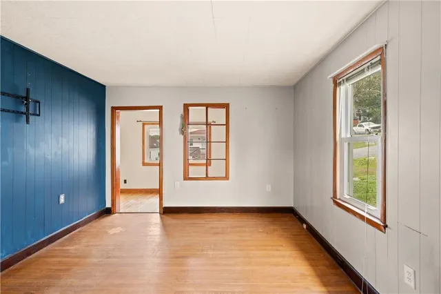 an empty room with windows and closet