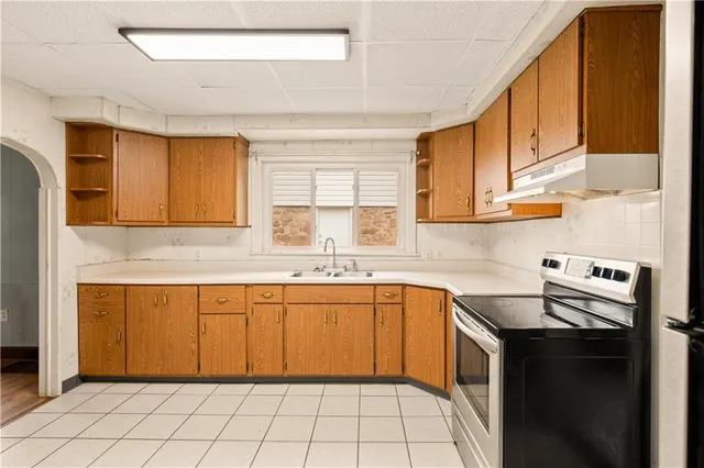 a kitchen with a sink stove and cabinets