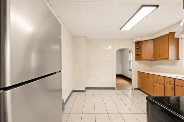 a view of a kitchen with a sink and a refrigerator