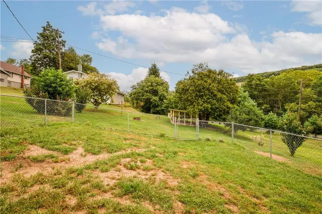 a swimming pool with an outdoor space and seating area
