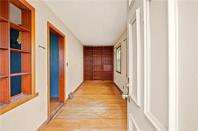 a view of a hallway with wooden floor and entryway