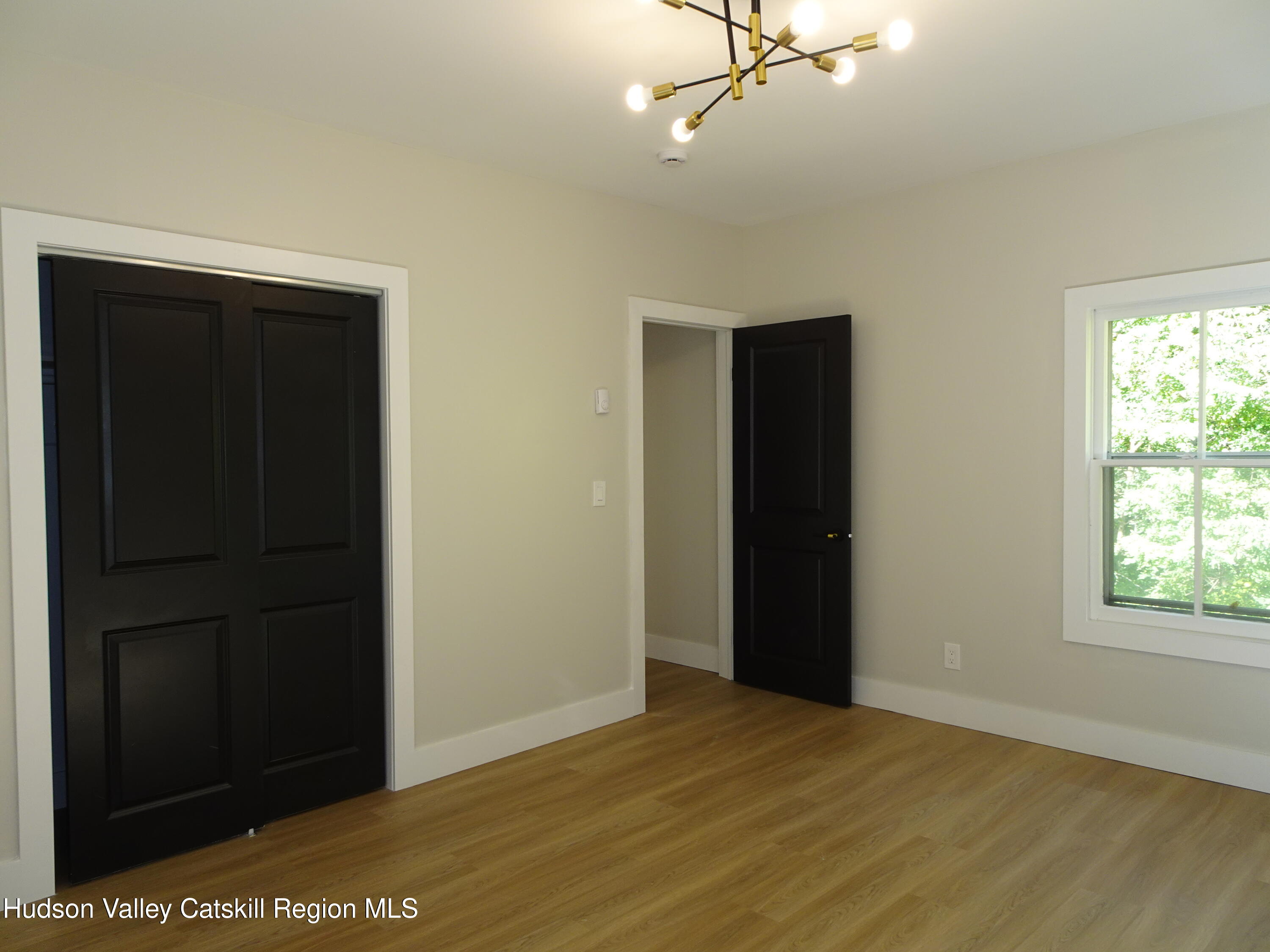 167 Highway 23, Unit 4C Claverack, NY 12513 - Photo 18 of 25 an empty room with windows and closet