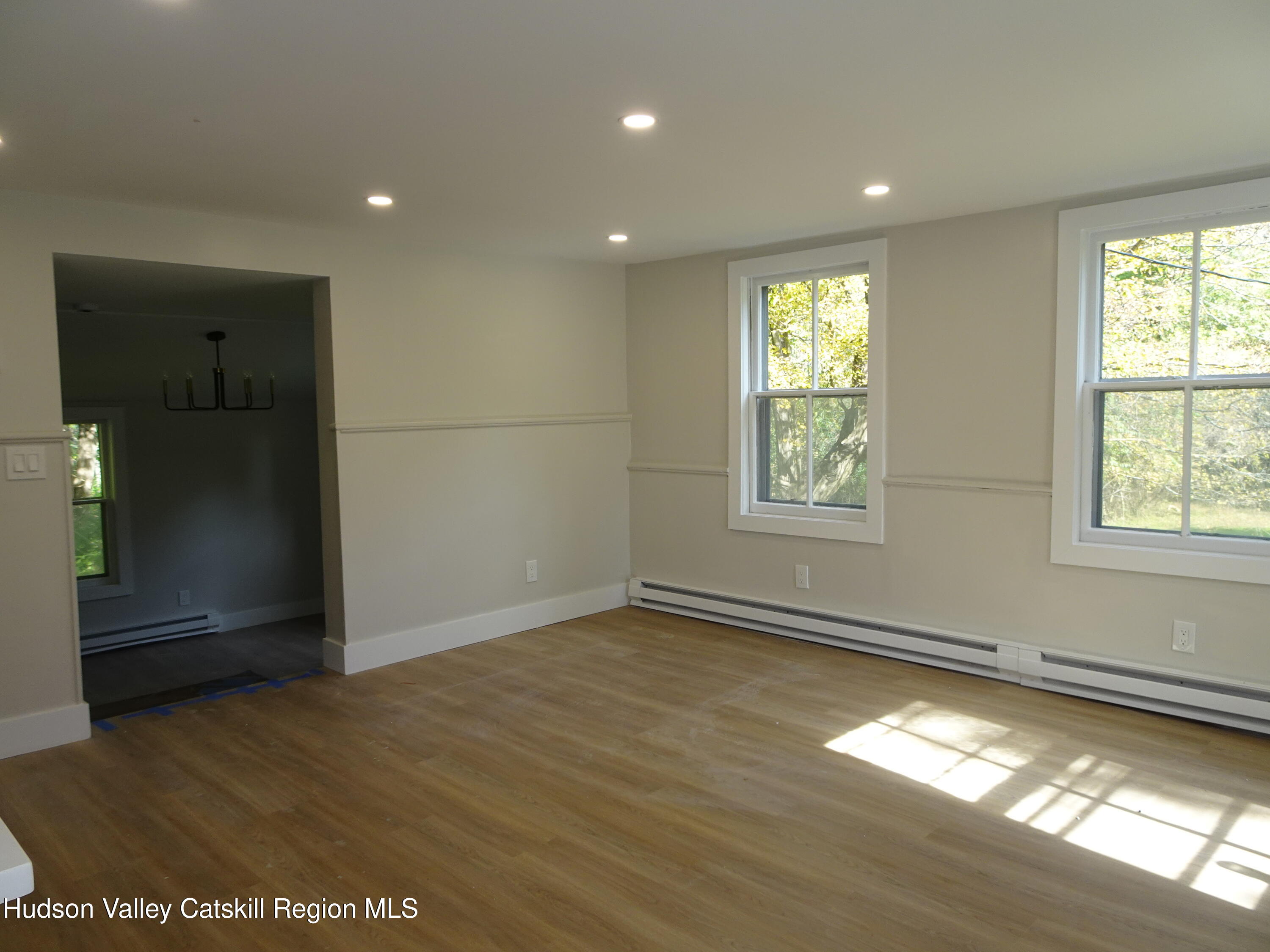 167 Highway 23, Unit 4C Claverack, NY 12513 - Photo 4 of 25 an empty room with wooden floor and windows