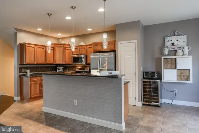 a view of kitchen with refrigerator and cabinets