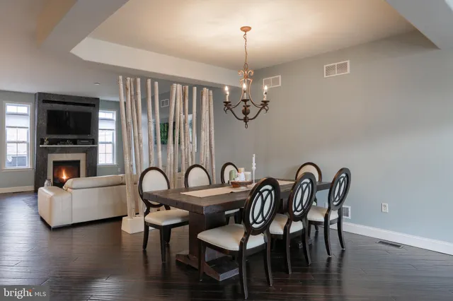 a view of a dining room with furniture wooden floor and chandelier