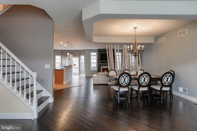 a view of a a dining room with furniture wooden floor and chandelier