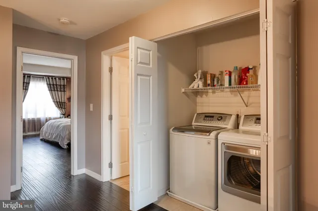 a view of walk in closet with wooden floor and bedroom view