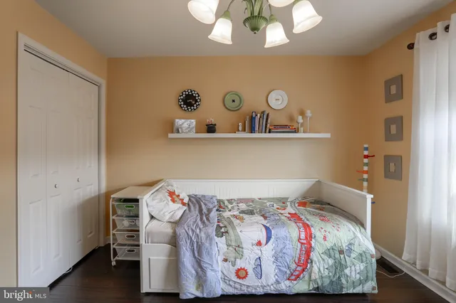 a bedroom with a bed and chandelier