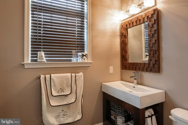 a bathroom with a sink a mirror and a window