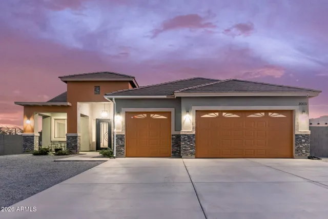 a front view of a house with a yard and garage