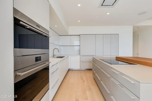 a view of a kitchen with kitchen island a large window in it