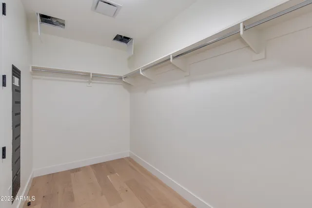 a view of a living room with a bed and cabinets