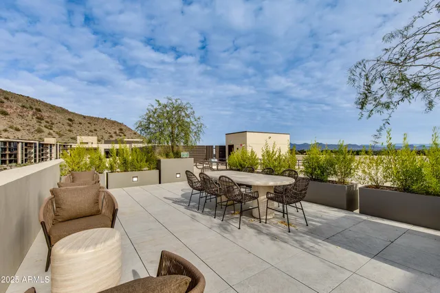 an aerial view of a house with swimming pool and patio